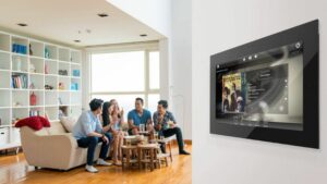 a group of friends in a living room with a smart tv on the wall